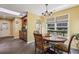Cozy dining area with a chandelier, tile floors, multiple windows, and wooden chairs around the table at 1390 Barclay Dr, Lawrenceville, GA 30043