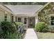 Charming front entrance with stone accents, a covered porch, and a well-maintained landscape at 1390 Barclay Dr, Lawrenceville, GA 30043