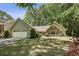 Attractive home with manicured lawn, mature trees, two-car garage, attractive stone and siding exterior at 1390 Barclay Dr, Lawrenceville, GA 30043