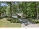 Inviting front yard featuring mature trees and an attractive home with a two-car garage and manicured lawn at 1390 Barclay Dr, Lawrenceville, GA 30043