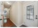 Inviting hallway with decorative front door, hardwood floors, and a view into the bathroom at 1390 Barclay Dr, Lawrenceville, GA 30043