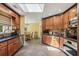 Bright eat-in kitchen with tile floors, wooden cabinets, stainless steel appliances, and a skylight at 1390 Barclay Dr, Lawrenceville, GA 30043