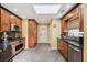 Spacious kitchen features stainless steel appliances, wooden cabinets, granite counters, and tile floors at 1390 Barclay Dr, Lawrenceville, GA 30043