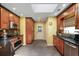Well-lit kitchen featuring wooden cabinets, dark countertops, stainless steel appliances, and tile flooring at 1390 Barclay Dr, Lawrenceville, GA 30043