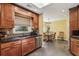 Eat-in kitchen featuring wooden cabinets, granite counters, tile backsplash, stainless steel appliances, and tile floors at 1390 Barclay Dr, Lawrenceville, GA 30043
