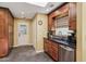 Kitchen with tile floors, granite counters, wooden cabinets, stainless steel appliances, and access to the backyard at 1390 Barclay Dr, Lawrenceville, GA 30043
