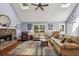 Spacious living room with vaulted ceilings, wood floors, a stone fireplace, and multiple skylights at 1390 Barclay Dr, Lawrenceville, GA 30043