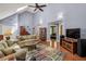 Open living room boasts vaulted ceilings, wood floors, and access to another room in the house at 1390 Barclay Dr, Lawrenceville, GA 30043
