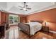 Spacious main bedroom with hardwood floors, tray ceiling, and a large window view at 1390 Barclay Dr, Lawrenceville, GA 30043