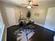Bedroom with dark hardwood floors, ceiling fan, and modern clockwork rug at 1900 Meadow Ln, Decatur, GA 30032