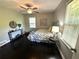 Cozy bedroom with natural light, ceiling fan, and dark hardwood floors at 1900 Meadow Ln, Decatur, GA 30032