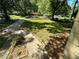 Home's front yard featuring mature trees and sidewalks at 1900 Meadow Ln, Decatur, GA 30032