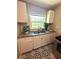 Kitchen featuring white cabinets, granite countertops and stainless steel sink, with white tiled backsplash at 1900 Meadow Ln, Decatur, GA 30032