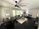Open-concept living and dining area featuring dark wood floors and a neutral color palette at 1900 Meadow Ln, Decatur, GA 30032