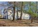 Side view of the home showing its partially finished basement and backyard at 409 Katherine Ln, Woodstock, GA 30189