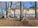 Wide view of the back of the home with fenced in area and partial basement at 409 Katherine Ln, Woodstock, GA 30189