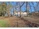Wide view of the back of home showing the basement entrance and partially fenced back yard at 409 Katherine Ln, Woodstock, GA 30189