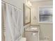 This bathroom features a granite countertop, bright lighting and a large towel rack at 409 Katherine Ln, Woodstock, GA 30189