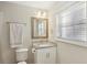 This bathroom offers a granite countertop, window, toilet, and towel rack at 409 Katherine Ln, Woodstock, GA 30189