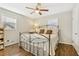 This bedroom has hardwood floors, ceiling fan, windows, and a bed with decorative metal frame at 409 Katherine Ln, Woodstock, GA 30189