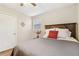 Comfortable bedroom featuring a ceiling fan, hardwood floors, and a bright window at 409 Katherine Ln, Woodstock, GA 30189