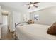 Bedroom with hardwood floors, ceiling fan, two doors, bed with metal frame and a window at 409 Katherine Ln, Woodstock, GA 30189