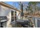 Deck with dining table, grill, and an umbrella for shade, perfect for outdoor enjoyment at 409 Katherine Ln, Woodstock, GA 30189