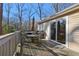 Outdoor deck area with dining table, grill, and a sliding glass door to the home's interior at 409 Katherine Ln, Woodstock, GA 30189