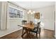 Cozy dining area with hardwood floors, a rustic table, and natural light from a window at 409 Katherine Ln, Woodstock, GA 30189
