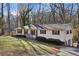 Charming single-story home with vinyl siding, black shutters, and a well-maintained front yard at 409 Katherine Ln, Woodstock, GA 30189
