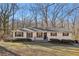 Inviting exterior view of a single-story home featuring a well-manicured lawn and mature trees at 409 Katherine Ln, Woodstock, GA 30189