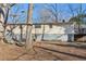 Exterior view of the back of the home with a deck and a spacious yard area at 409 Katherine Ln, Woodstock, GA 30189