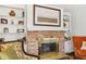 Close-up of a charming brick fireplace with a brass screen and decorative mantel at 409 Katherine Ln, Woodstock, GA 30189