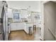Eat-in kitchen showcasing granite countertops, stainless steel appliances, and an eat-in bar at 409 Katherine Ln, Woodstock, GA 30189