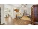 Bright living room boasts hardwood floors, neutral decor, and access to kitchen at 409 Katherine Ln, Woodstock, GA 30189
