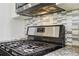 Close up view of a stainless steel range and hood at 409 Katherine Ln, Woodstock, GA 30189