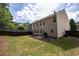 Well-maintained backyard with lush green grass, a privacy fence, and a patio area at 120 Park Village Dr, Canton, GA 30114