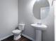 A half bathroom featuring a pedestal sink, oval mirror and updated fixtures at 120 Park Village Dr, Canton, GA 30114