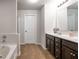 Modern bathroom with double vanity, dark wood cabinets, and a separate bathtub and shower at 120 Park Village Dr, Canton, GA 30114