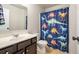 Bright bathroom featuring a single sink vanity and a playful dinosaur-themed shower curtain at 120 Park Village Dr, Canton, GA 30114