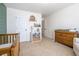 A bright Bedroom featuring a wooden crib and storage shelves at 120 Park Village Dr, Canton, GA 30114