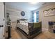 Charming bedroom design with wood accent wall, decorative ladder, and blue and white checkered curtains at 120 Park Village Dr, Canton, GA 30114