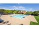 Stunning community pool with ample lounge chairs and a clubhouse in the background at 120 Park Village Dr, Canton, GA 30114