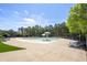 Beautiful community pool area with sun loungers, umbrellas, and lush green surroundings at 120 Park Village Dr, Canton, GA 30114