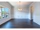 Elegant dining room with hardwood floors, wainscoting, chandelier, and a large window at 120 Park Village Dr, Canton, GA 30114