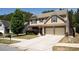 Traditional-style house showcasing a well-maintained lawn, extended driveway, and inviting curb appeal at 120 Park Village Dr, Canton, GA 30114