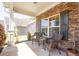 Cozy front porch with stone accent wall and wicker seating area, perfect for relaxing outdoors at 120 Park Village Dr, Canton, GA 30114