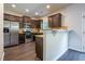 A modern kitchen with stainless steel appliances, a breakfast bar and dark wood cabinets at 120 Park Village Dr, Canton, GA 30114