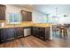 Well-lit kitchen featuring stainless steel appliances, dark wood cabinets and wooden floor at 120 Park Village Dr, Canton, GA 30114