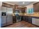 Spacious kitchen featuring stainless steel appliances, granite countertops, and dark wood cabinetry at 120 Park Village Dr, Canton, GA 30114